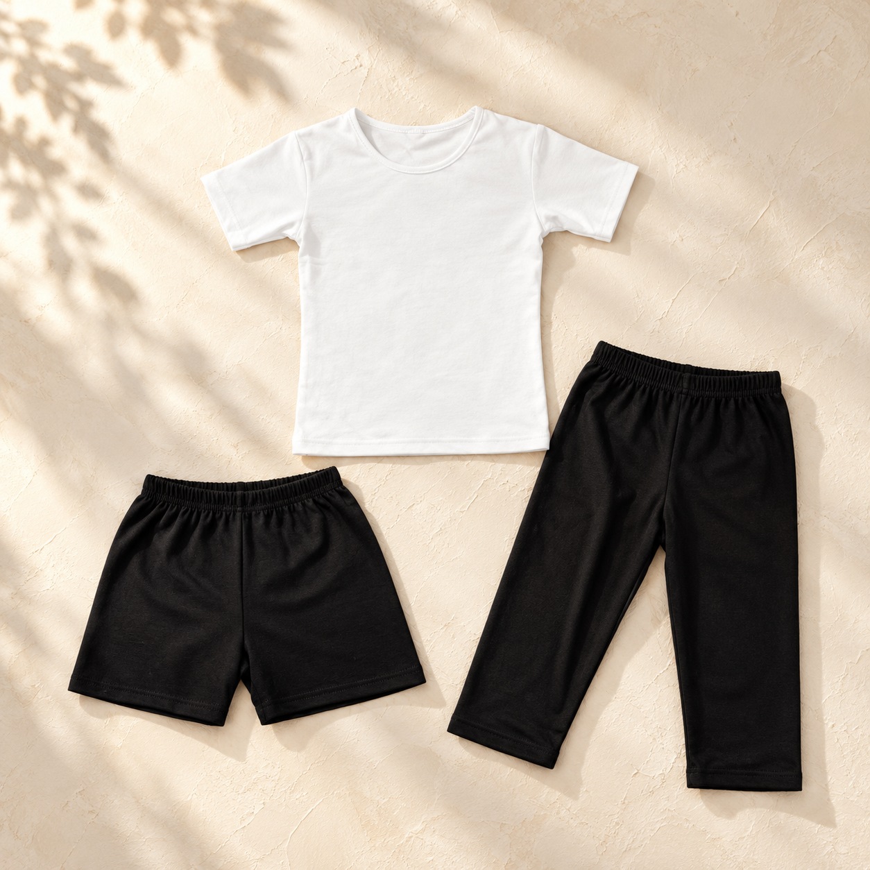 Boys ballet practice set showing white top, black shorts and black cropped trousers