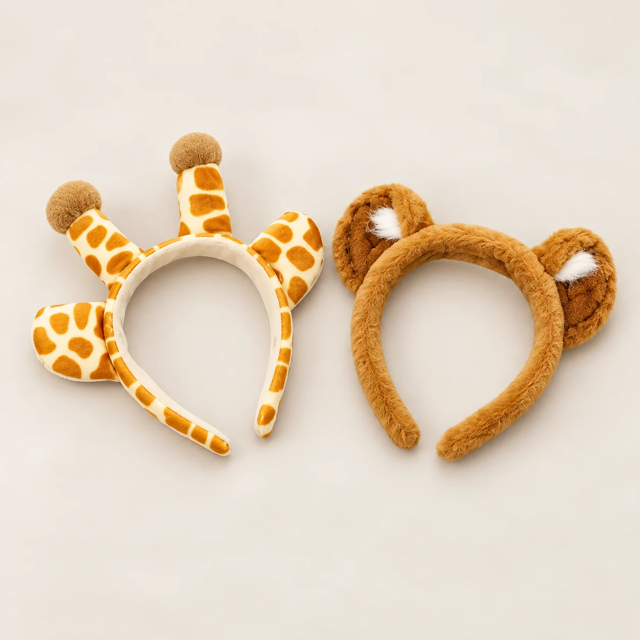 Plush bear ear headband and giraffe ear headband side by side