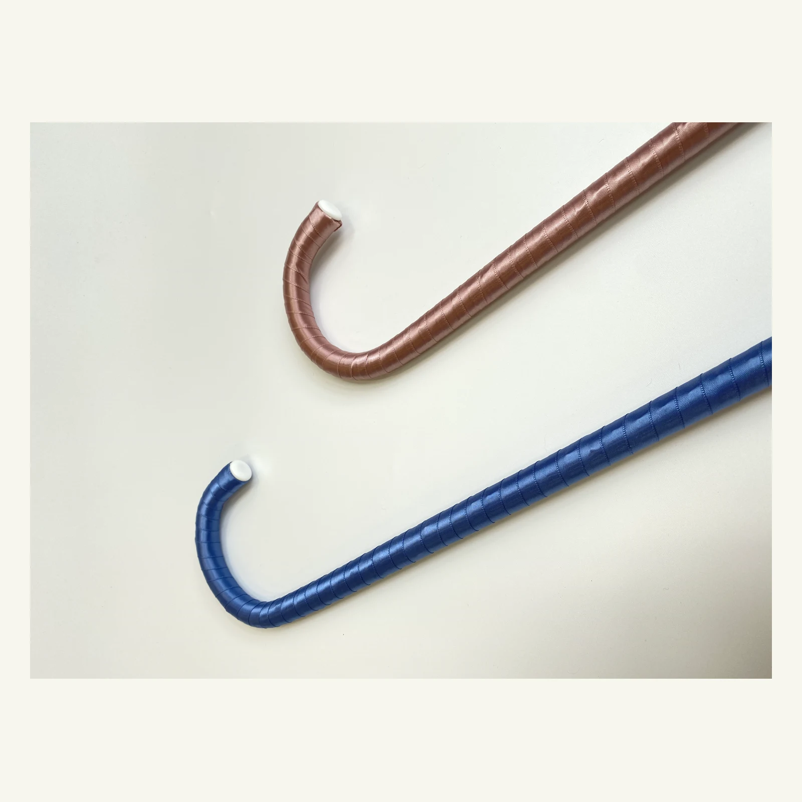 Close-up of the hooked handles of the blue and pink canes