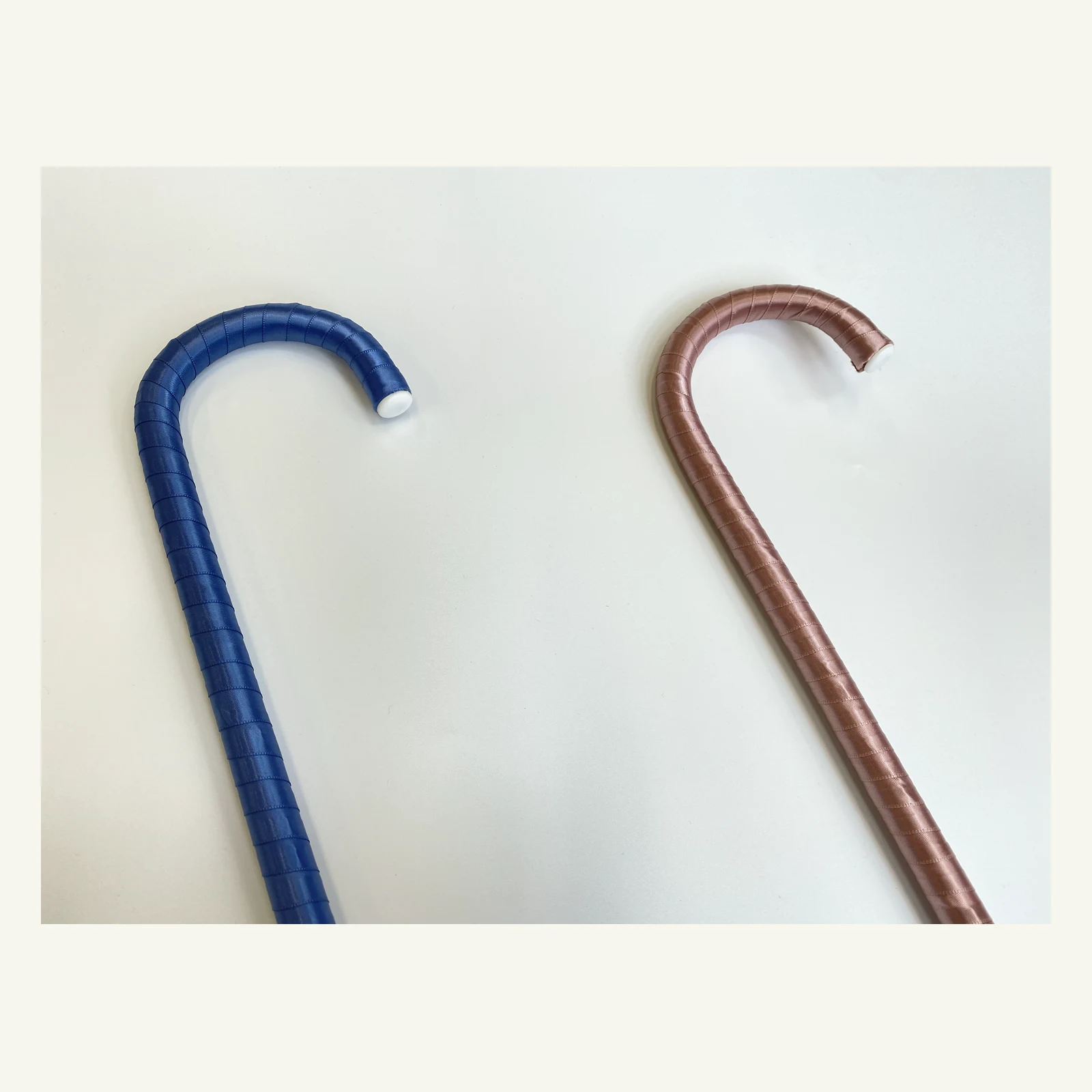 Blue and pink ballet cane handles shown together