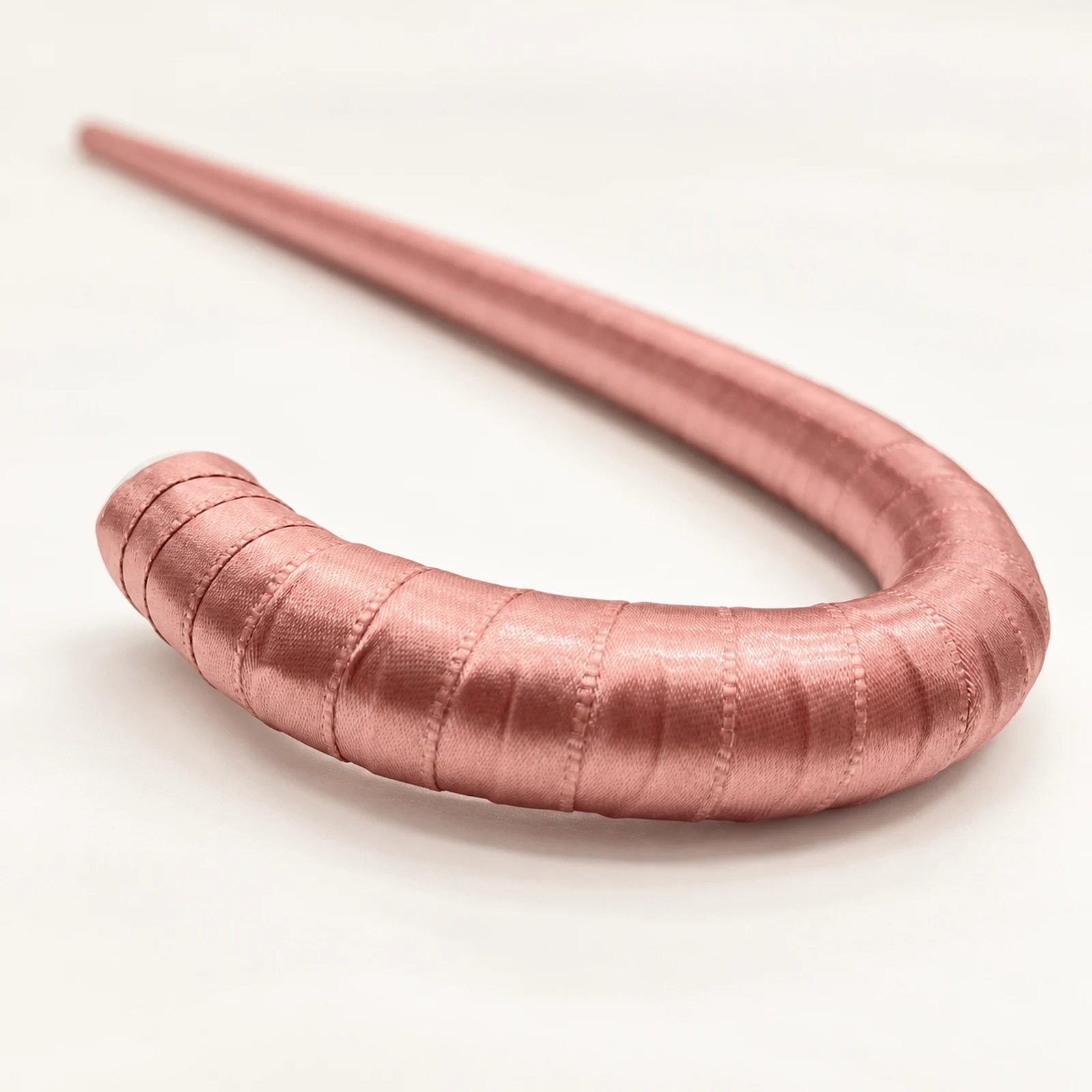 Close-up of the satin-wrapped handle of the pink cane