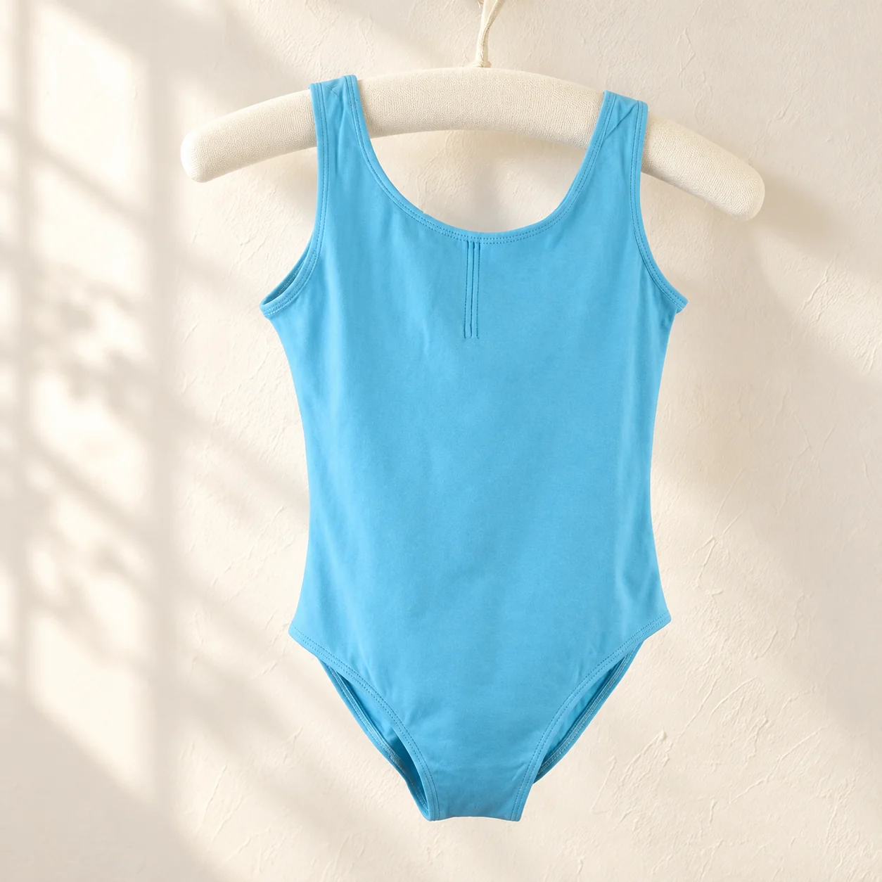 Lake blue sleeveless cotton ballet leotard on a hanger