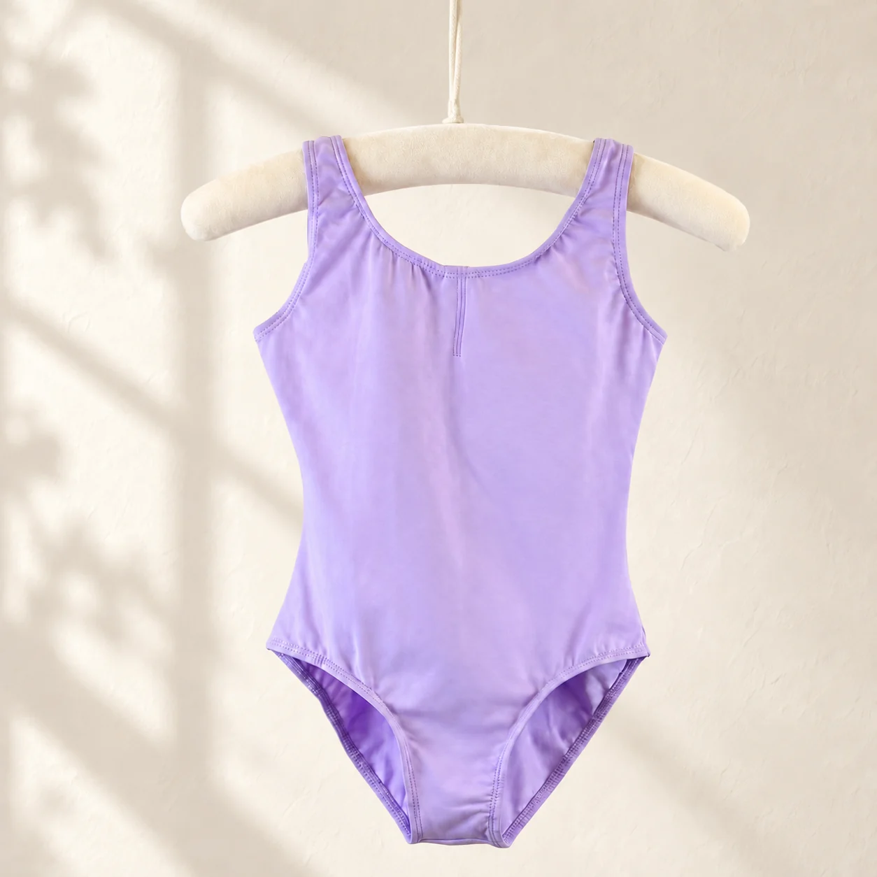Lavender sleeveless cotton ballet leotard on a hanger