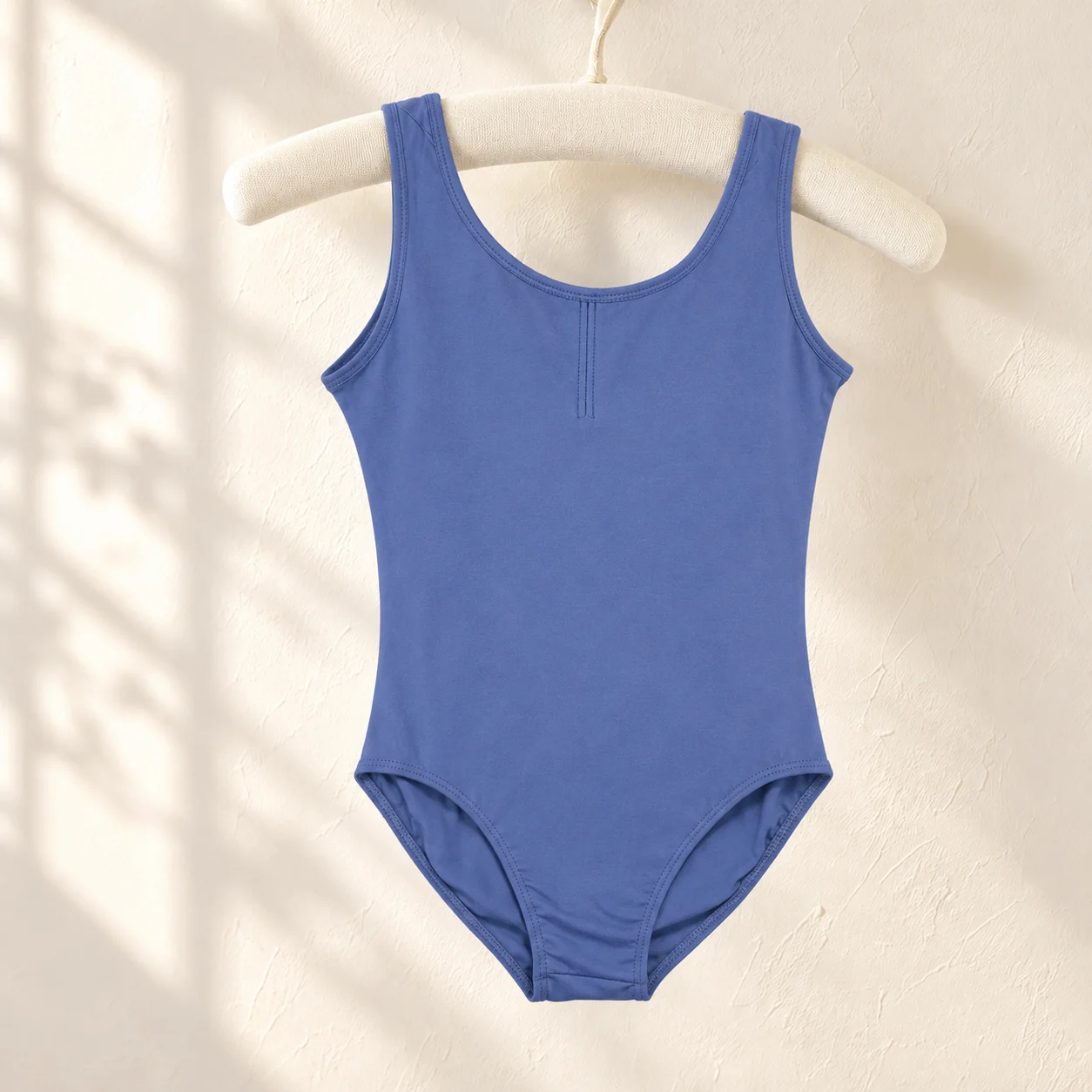 Sea blue sleeveless nylon ballet leotard on a hanger