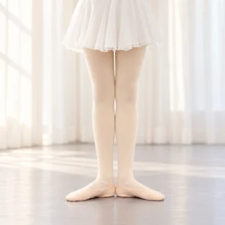 Dancer in ballet pink tights and ballet shoes standing in first position