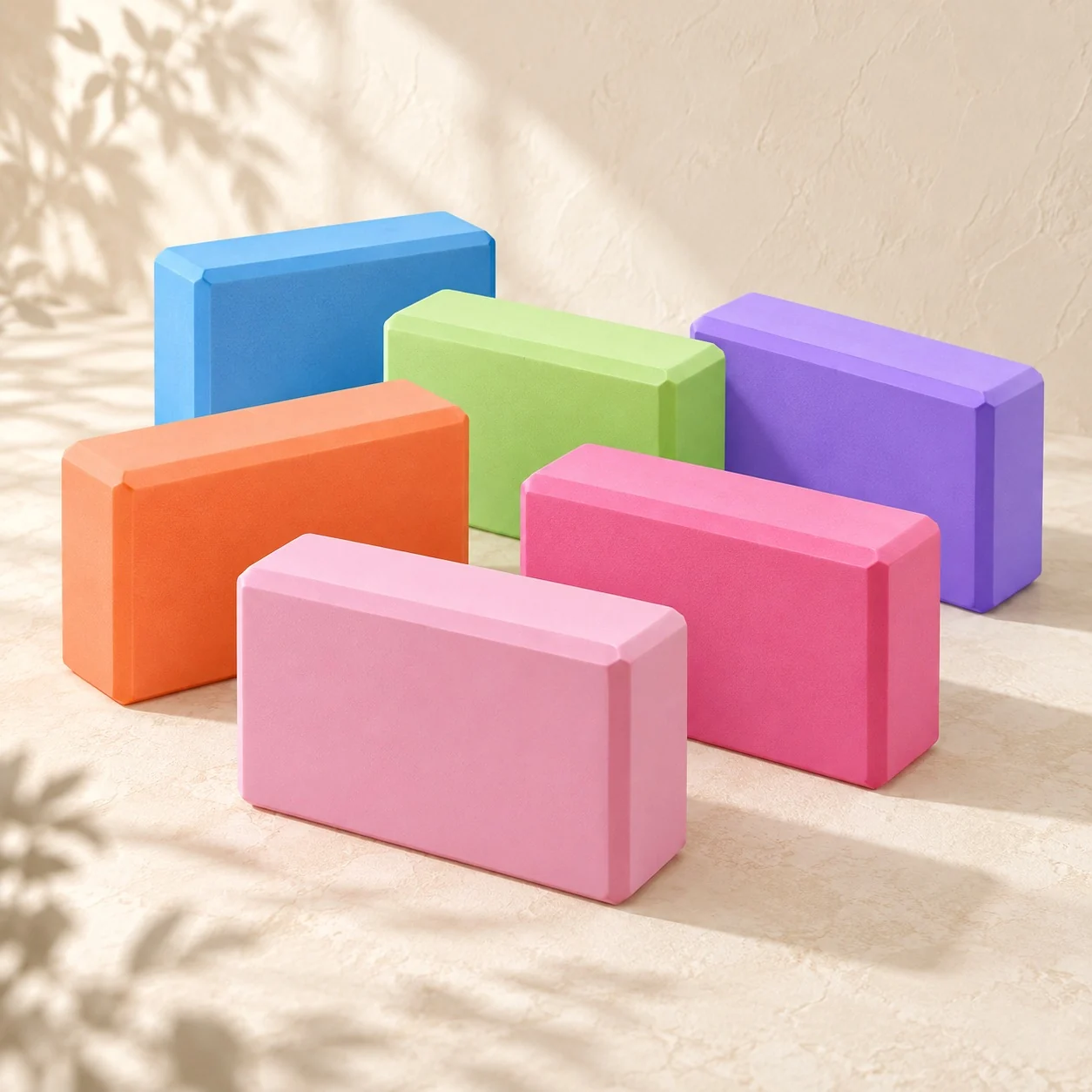 Six foam training blocks in pink, orange, blue, green, rose and purple on a cream floor