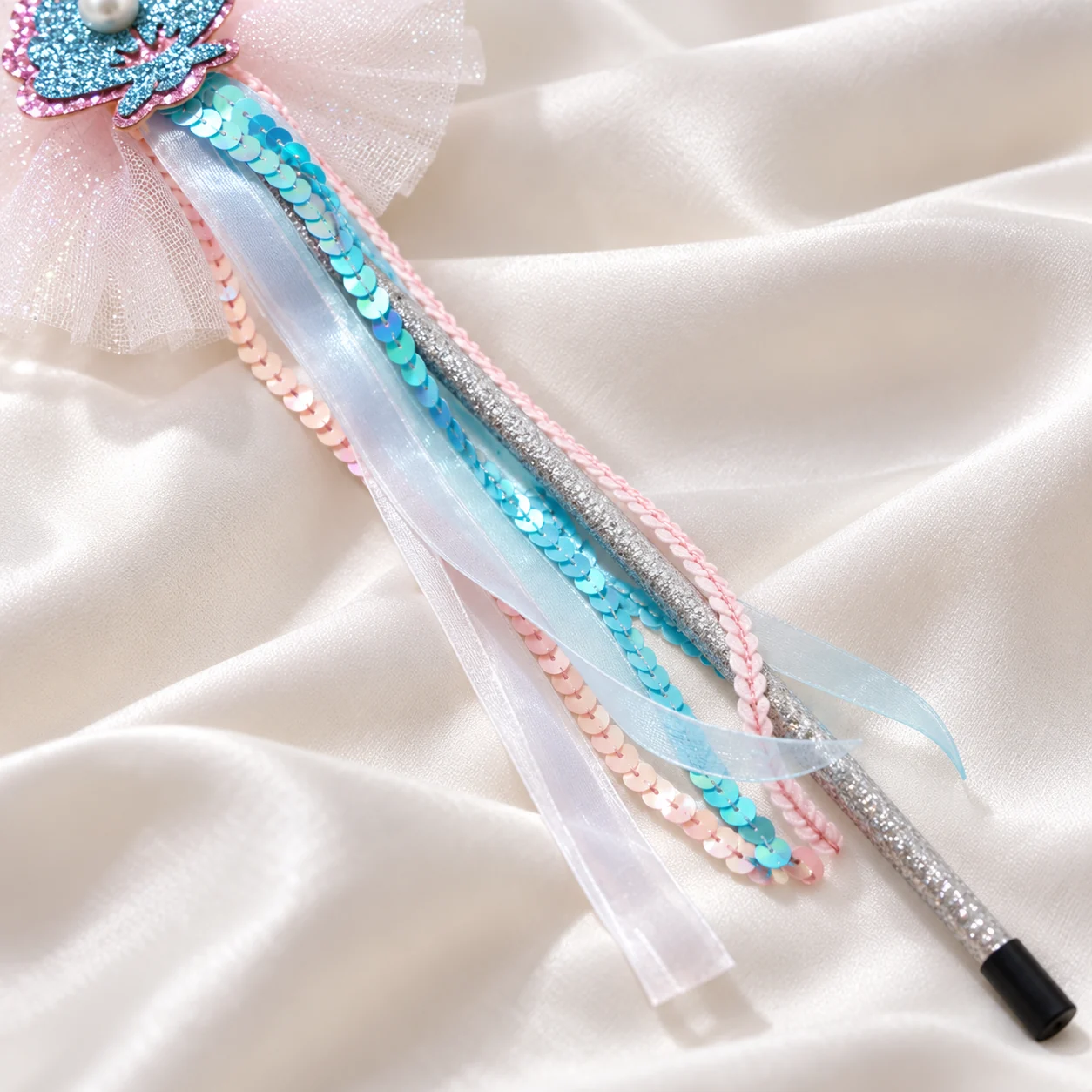 Close-up of the sequin and satin ribbon streamers on the fairy wand