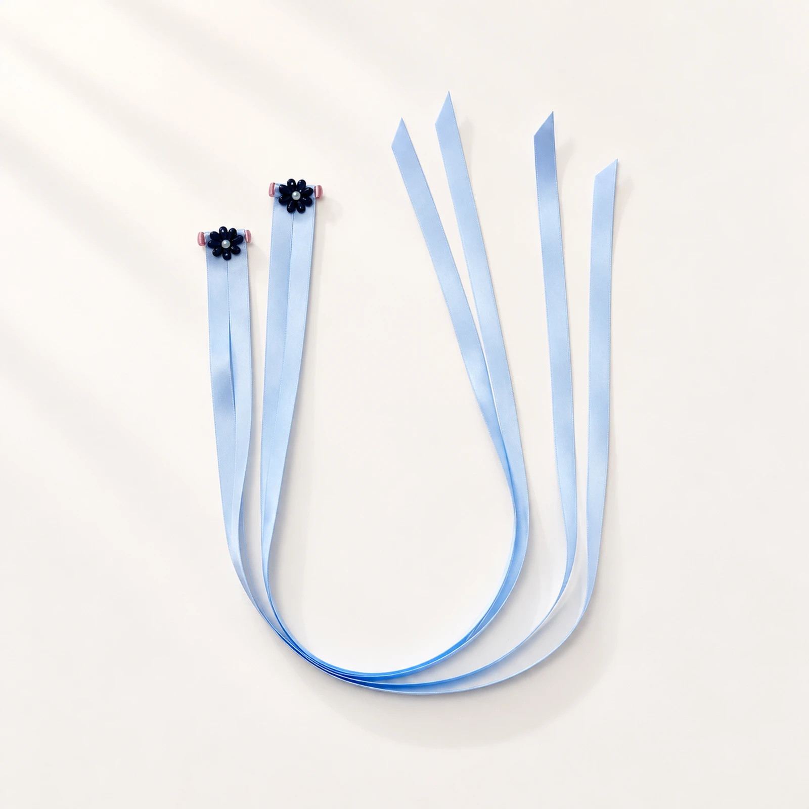 Pair of pale blue satin finger ribbons with small flower loops