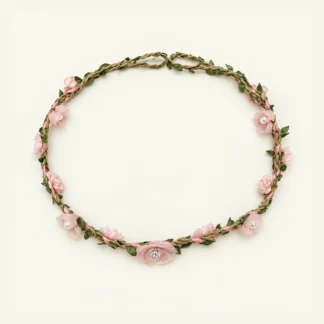 Pink flower and leaf wreath with pearl centers on a white background