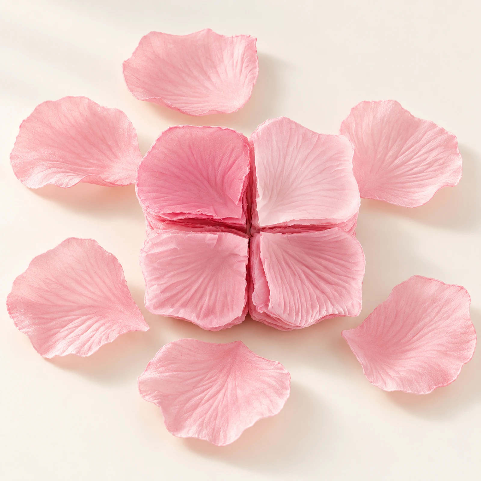 Blush pink fabric flower petals arranged around a stack