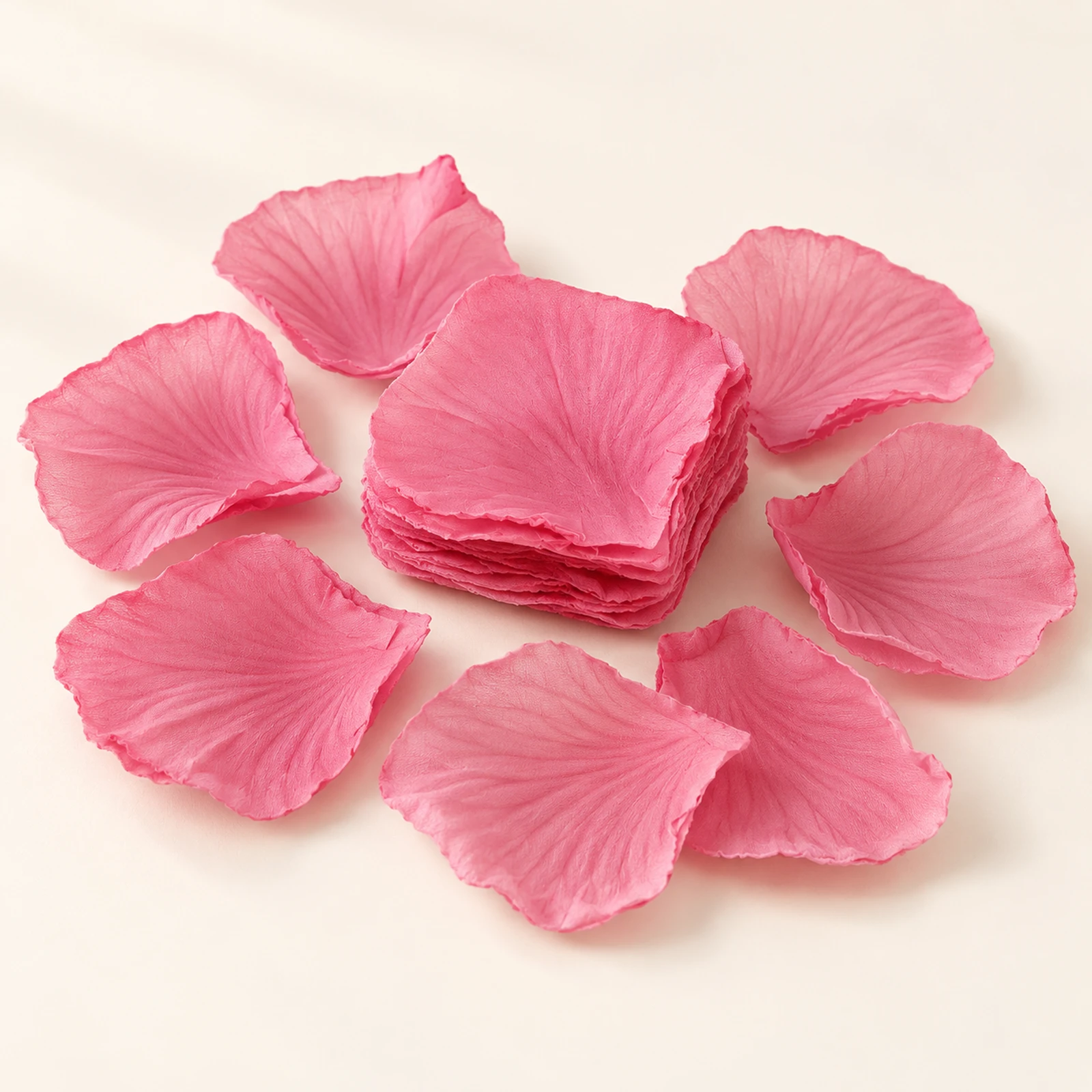 Deep rose fabric flower petals arranged around a stack