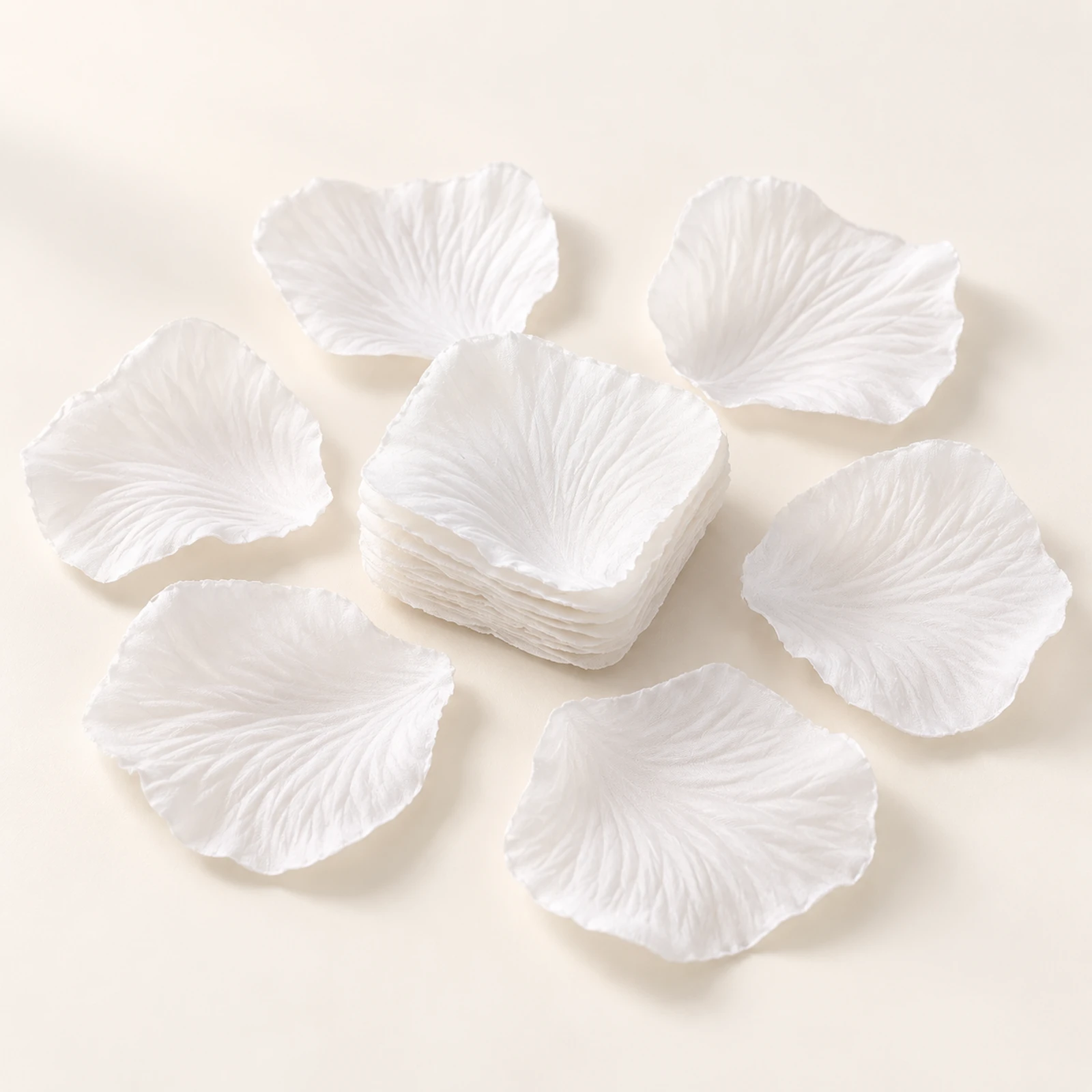 White fabric flower petals arranged around a stack