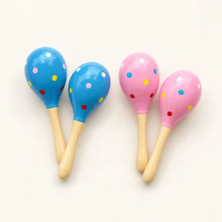 Two pairs of painted wooden hand shakers, one pair in blue and one in pink, with colorful dots