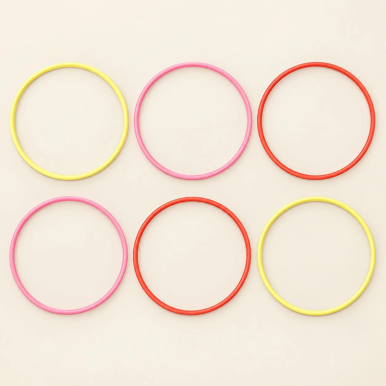 Six hoops laid flat: two yellow, two pink and two red
