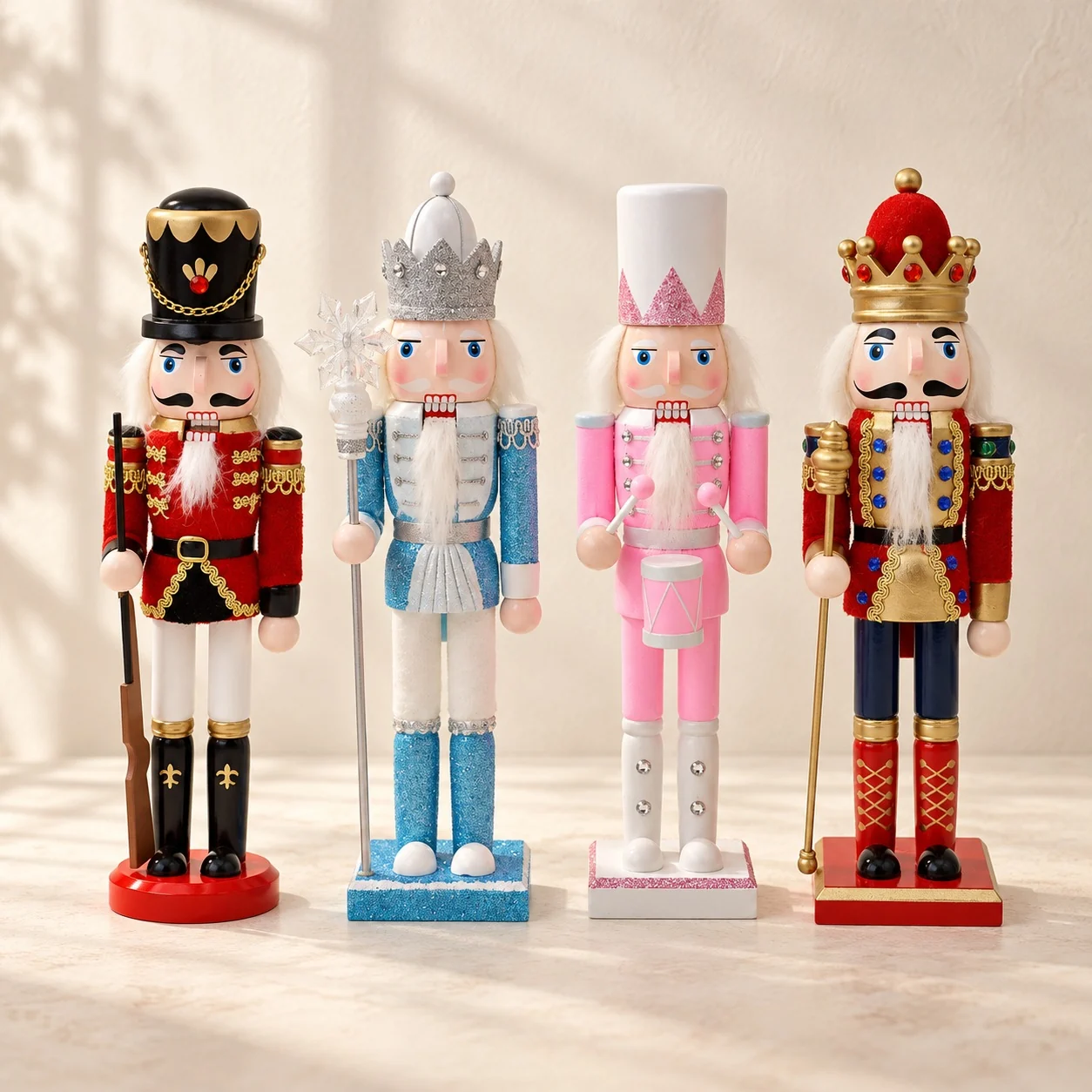 Four painted nutcracker figures in red, ice blue, pink and red and navy standing in a row