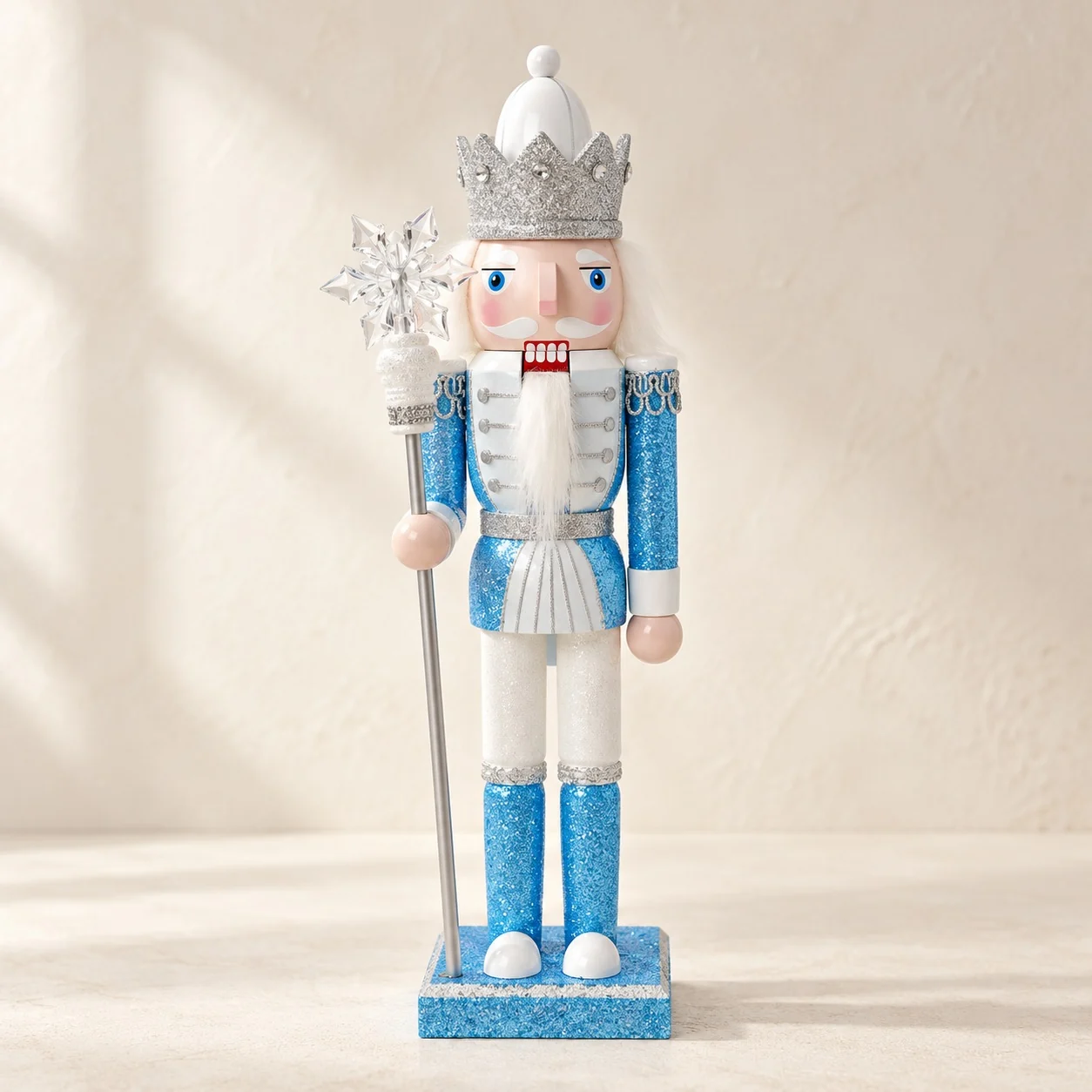Ice blue nutcracker with a silver crown and a snowflake scepter