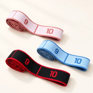 Three rolled stretch bands in blush pink, pale blue and black with red edges, each with numbered loops